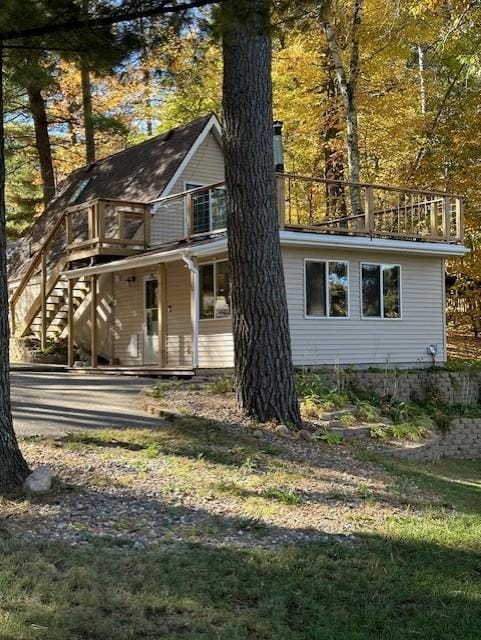 view of side of property featuring stairway