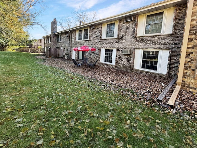 rear view of house featuring a lawn