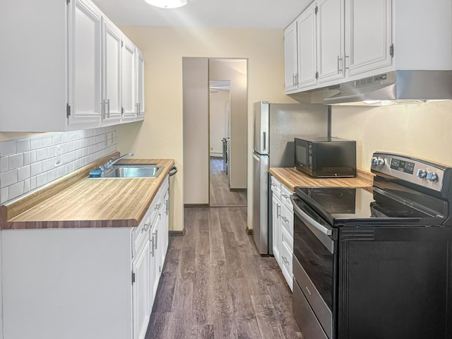 kitchen featuring stainless steel electric stove, decorative backsplash, white cabinetry, and sink