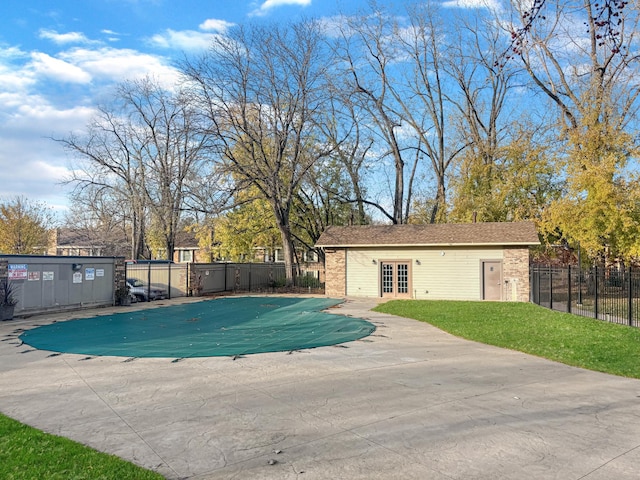 view of pool featuring a patio, an outdoor structure, and a lawn