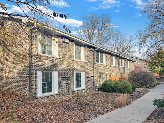 view of side of property with a wall mounted AC