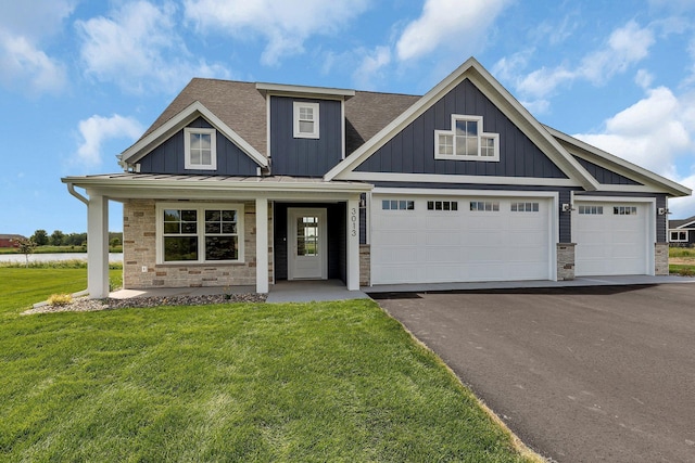 craftsman inspired home with a porch, a garage, and a front lawn