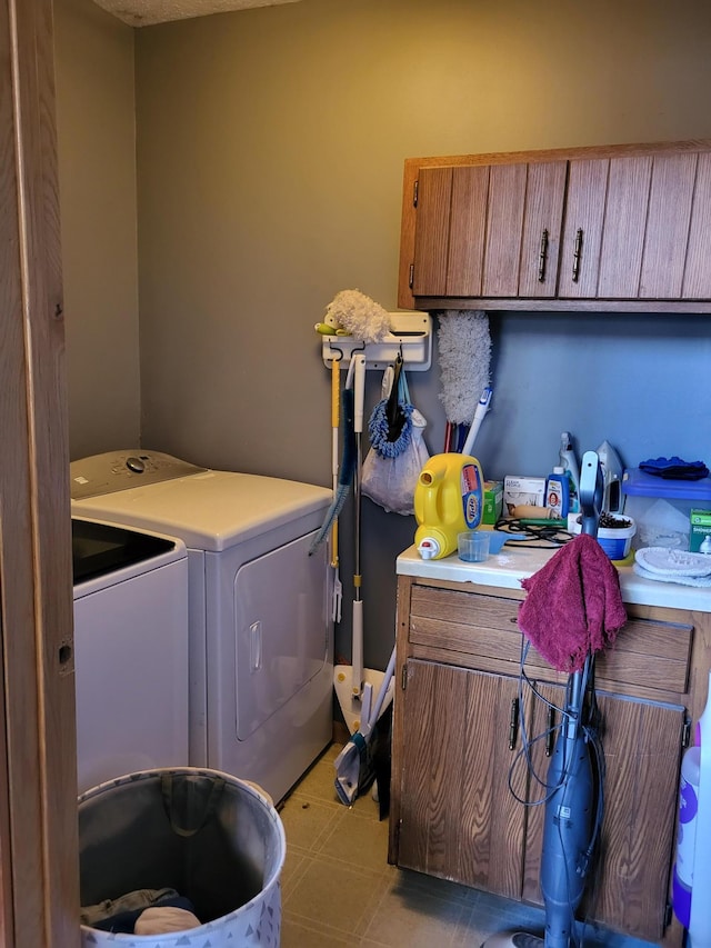 washroom with cabinets and washing machine and dryer