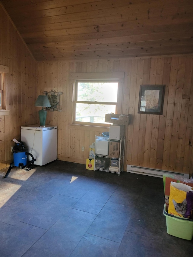 misc room featuring baseboard heating, wooden walls, wood ceiling, and vaulted ceiling