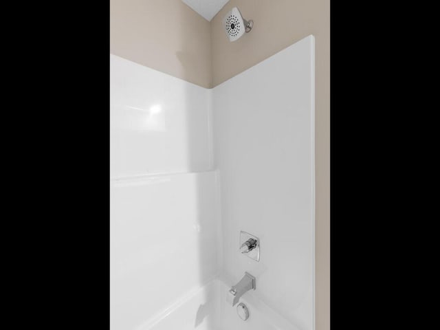 room details featuring tub / shower combination