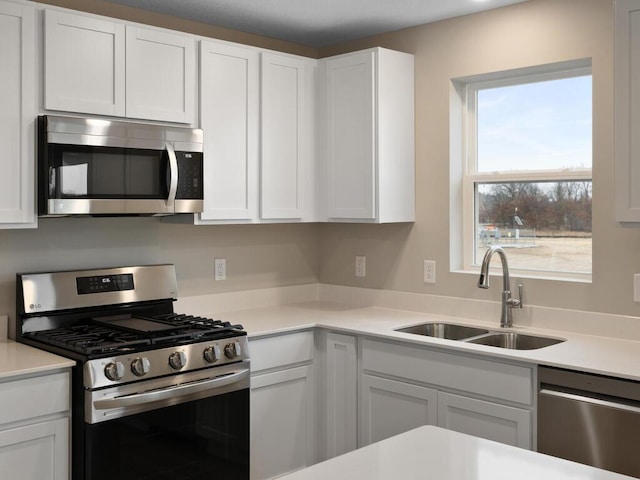 kitchen with white cabinets, stainless steel appliances, and sink