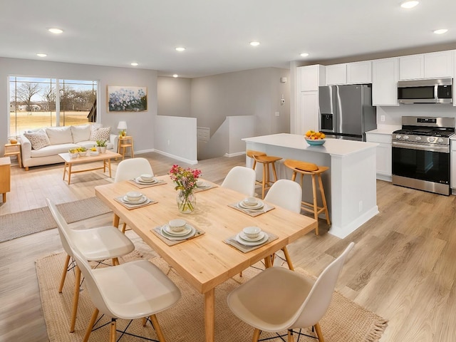 dining space with light hardwood / wood-style floors