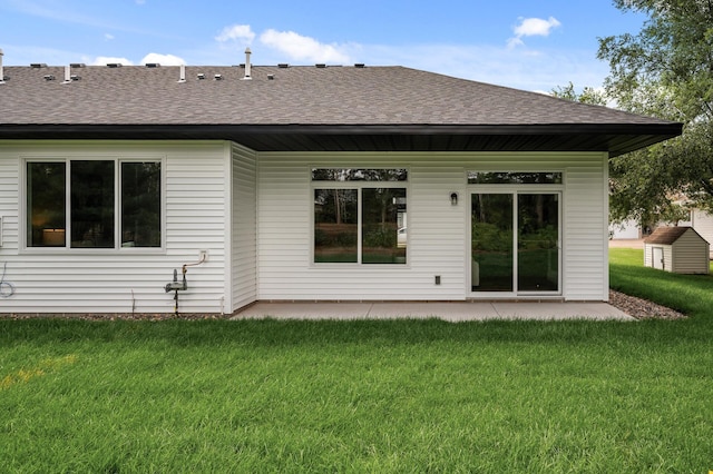 back of house with a patio area and a yard