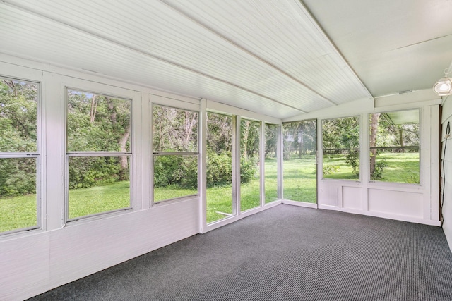 unfurnished sunroom featuring lofted ceiling