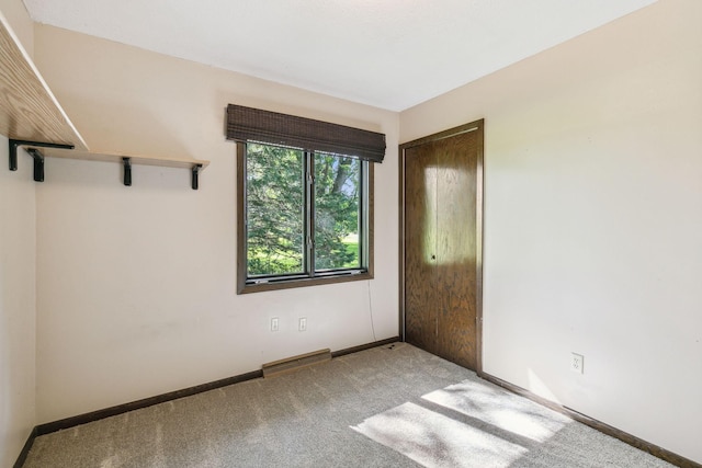 spare room featuring light colored carpet