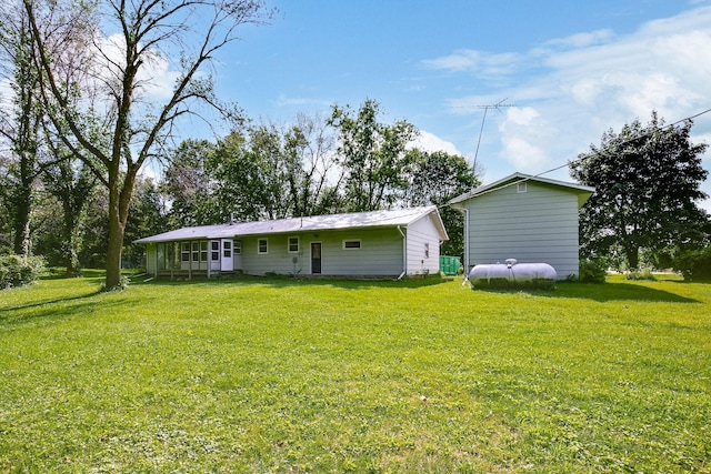 back of property with a lawn