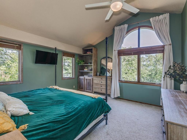 carpeted bedroom with multiple windows, lofted ceiling, and ceiling fan