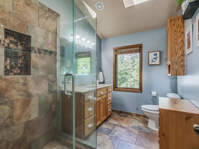 bathroom with vaulted ceiling, vanity, toilet, and a shower with door