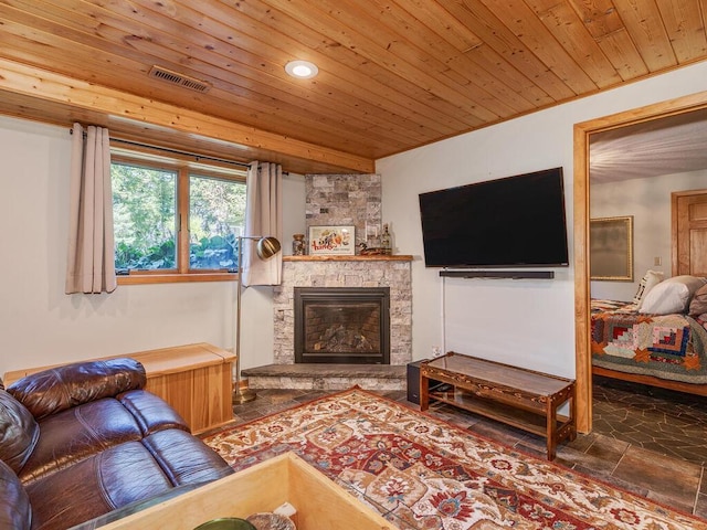 living room with a stone fireplace and wood ceiling