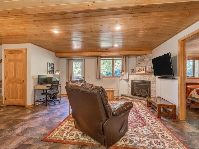 living room with a stone fireplace and wooden ceiling