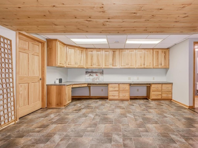 kitchen featuring light brown cabinetry and built in desk