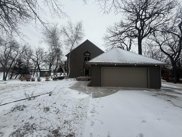 snow covered property featuring a garage