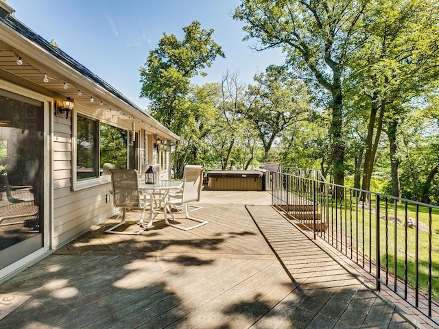 wooden terrace featuring a hot tub