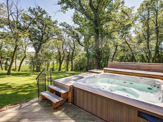 wooden terrace with a hot tub and a lawn