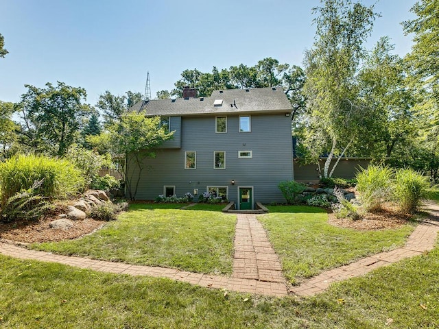 rear view of house with a lawn