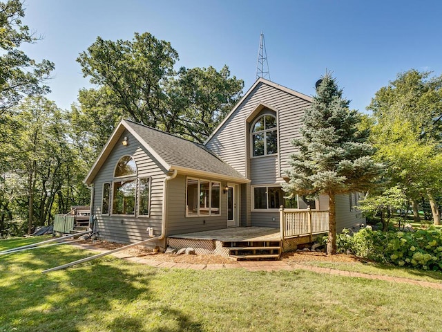 rear view of property with a deck and a lawn