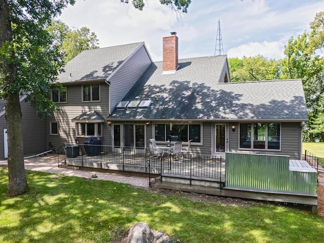 back of house featuring a wooden deck, a yard, and central air condition unit