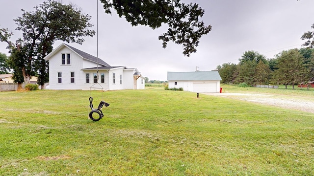 view of yard featuring an outbuilding and a garage