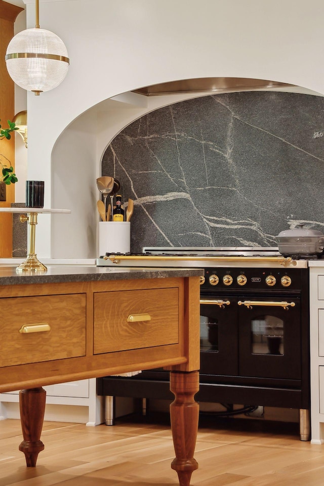 bar featuring tasteful backsplash and hanging light fixtures