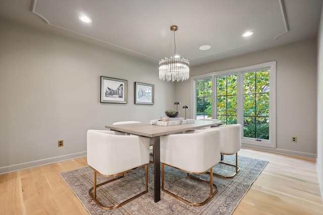 dining area with an inviting chandelier and light wood-type flooring