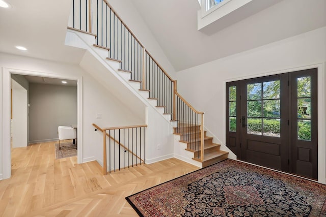 entrance foyer with a high ceiling and light parquet flooring