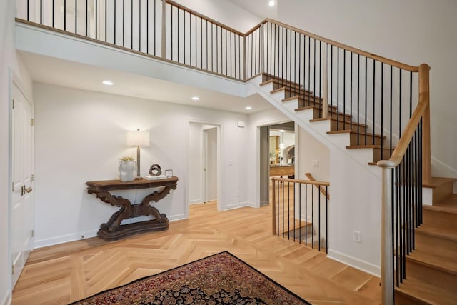 interior space with parquet floors and a high ceiling