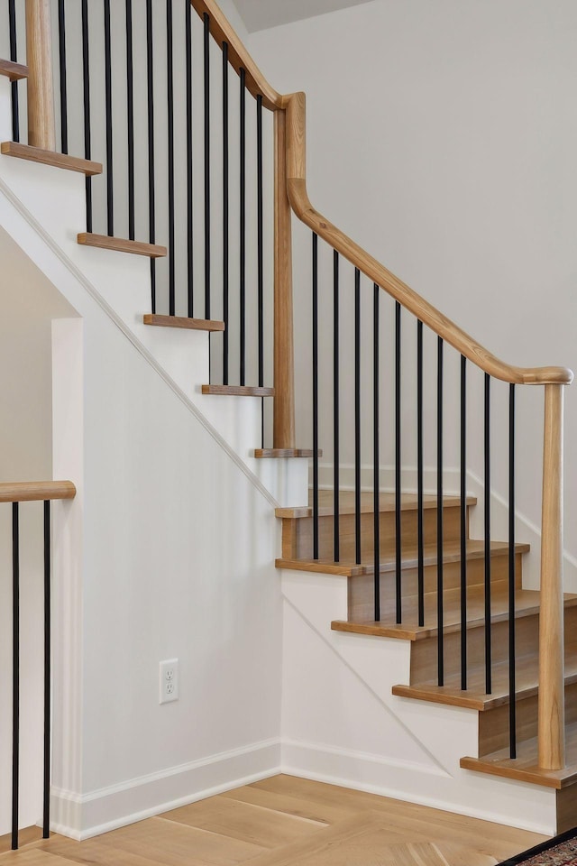 staircase featuring wood-type flooring