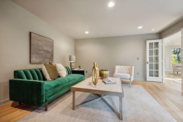 living room with light hardwood / wood-style flooring and french doors