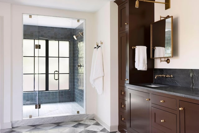 bathroom with vanity and a shower with door