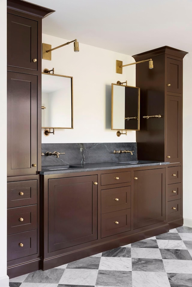 interior space with sink and dark brown cabinets