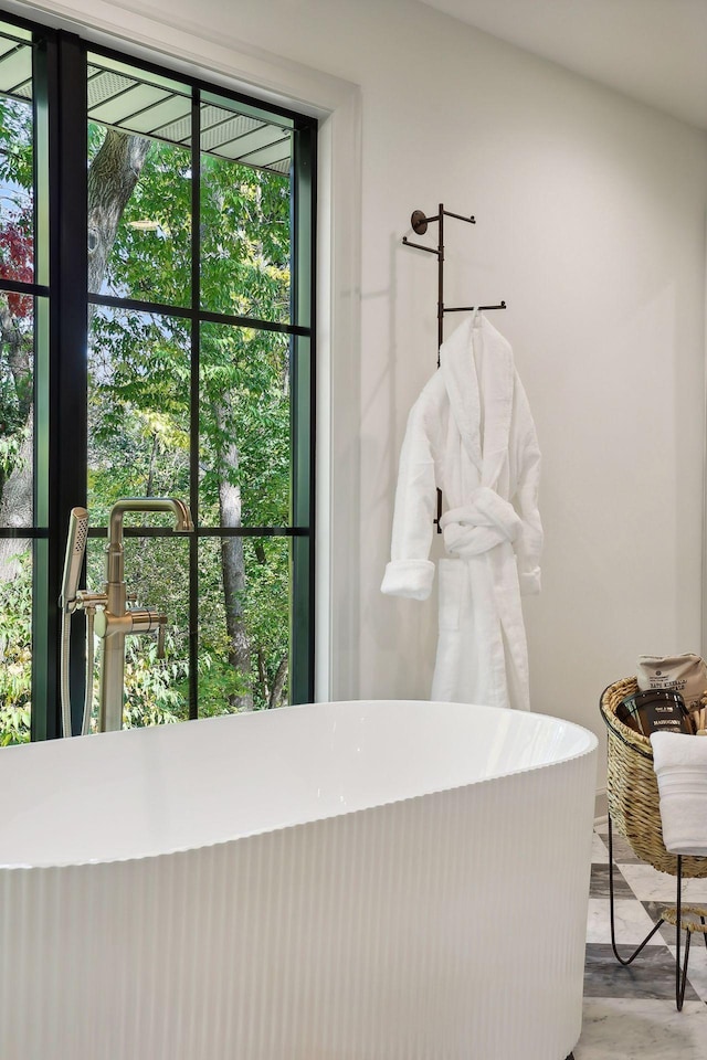 bathroom featuring a tub to relax in and hardwood / wood-style floors