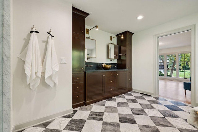 bathroom featuring recessed lighting, baseboards, and vanity