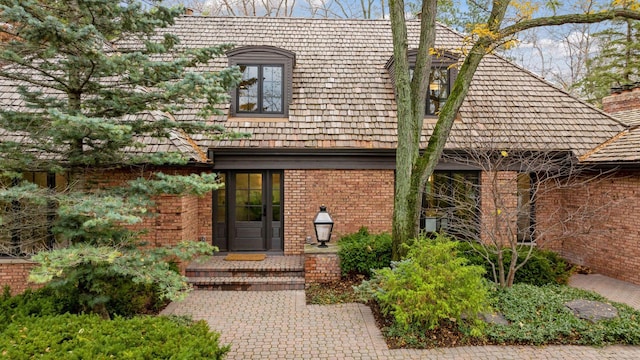 doorway to property featuring brick siding