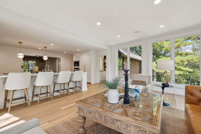 living room with recessed lighting and light wood finished floors