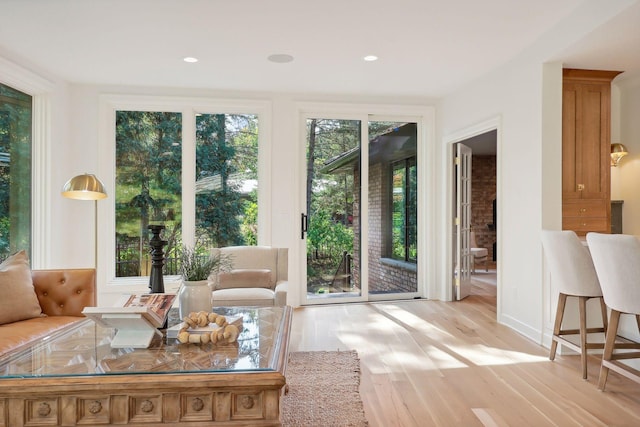 living area featuring recessed lighting and light wood-style flooring