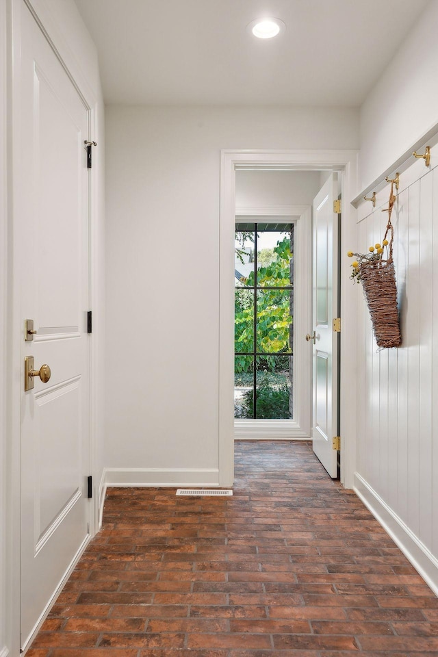 entryway featuring recessed lighting, baseboards, and brick floor