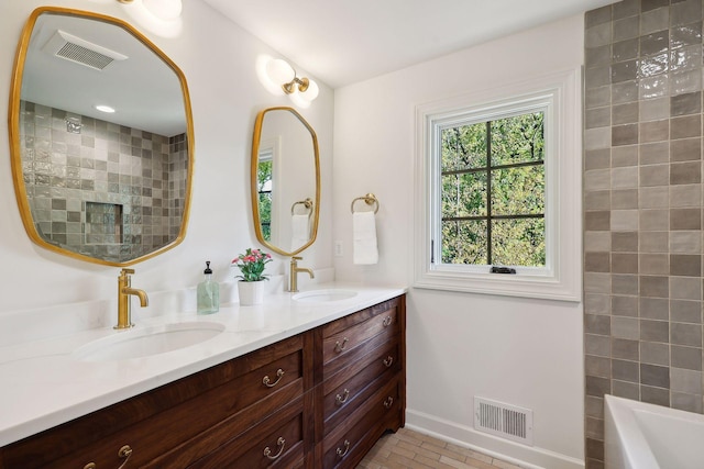 full bath featuring a sink, visible vents, and brick floor