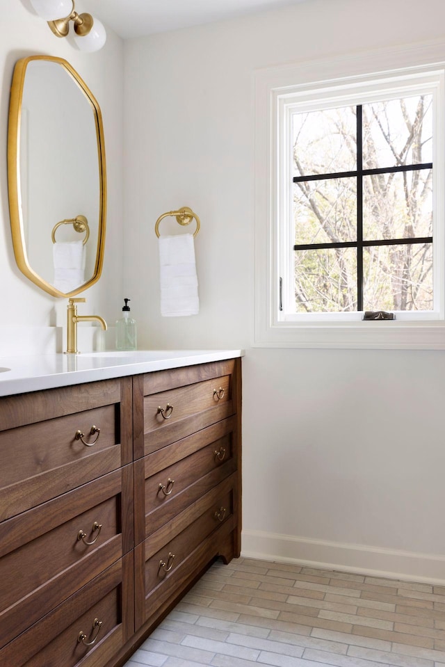 bathroom with baseboards and vanity