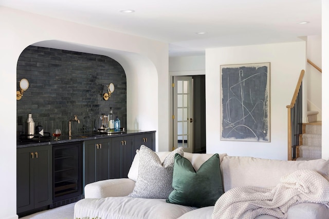 living area featuring wet bar, stairway, recessed lighting, and wine cooler