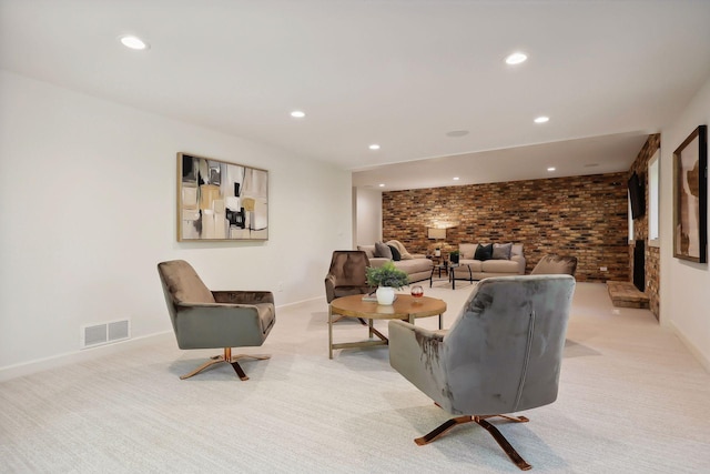 living room featuring recessed lighting, light colored carpet, visible vents, and brick wall