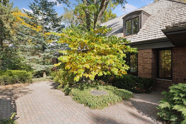 view of side of home featuring brick siding