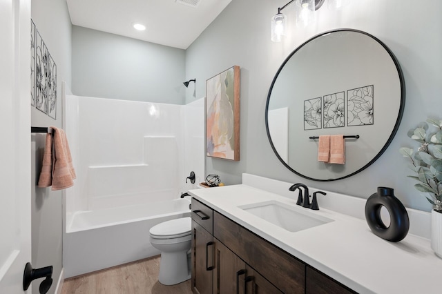 full bathroom featuring vanity, wood-type flooring, shower / bathtub combination, and toilet