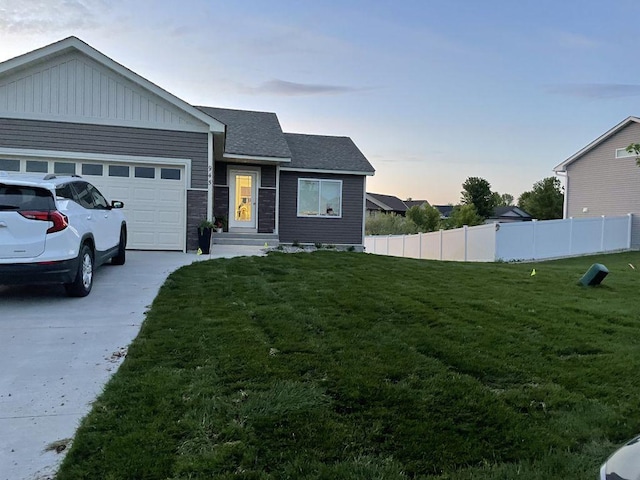 view of front of property with a lawn and a garage