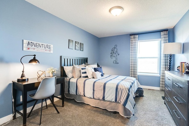 bedroom featuring carpet flooring and a textured ceiling