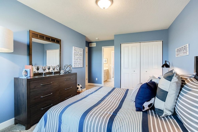 bedroom with ensuite bathroom, a closet, and light colored carpet